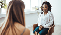 A female therapist meets with her Black client and thinks about how to better serve Black clients