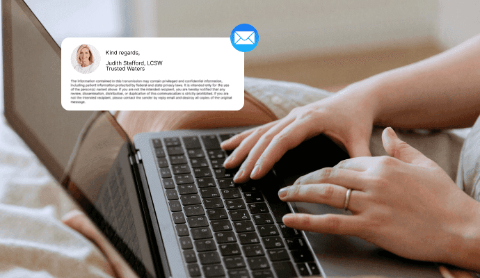 Female therapist typing a HIPAA-compliant email message to a client