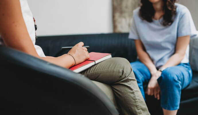 A female therapist discusses the exceptions to confidentiality in counseling with her female client