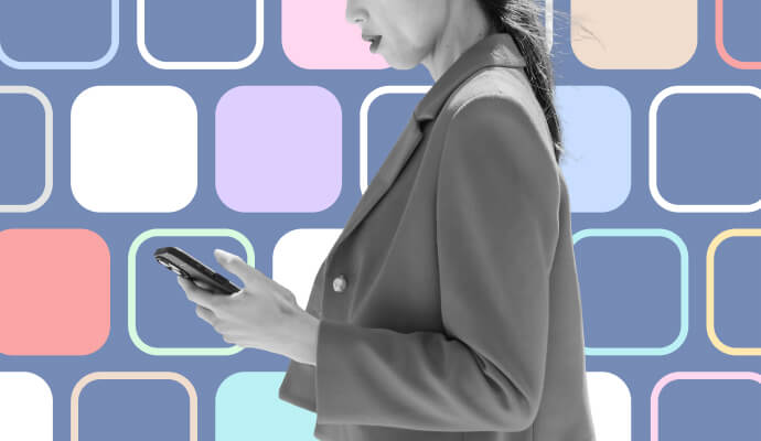 A woman holding a phone in front of a collage of purple and white squares.