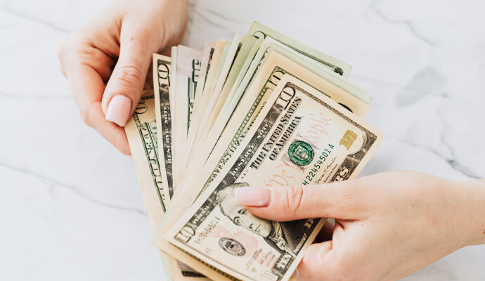 A woman's hands holding money