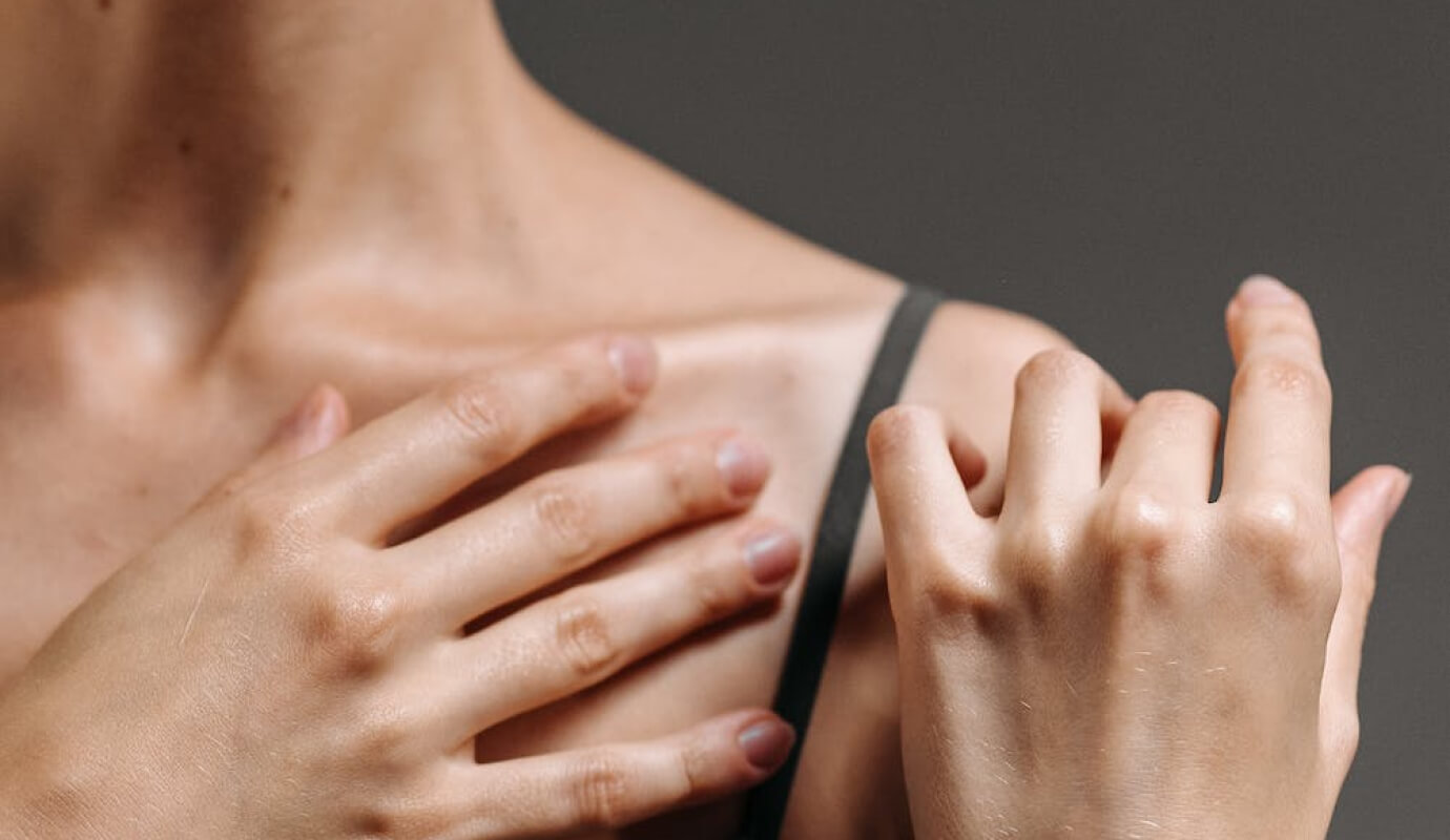 Female therapist massages her pained shoulder while doing her therapist self care plan