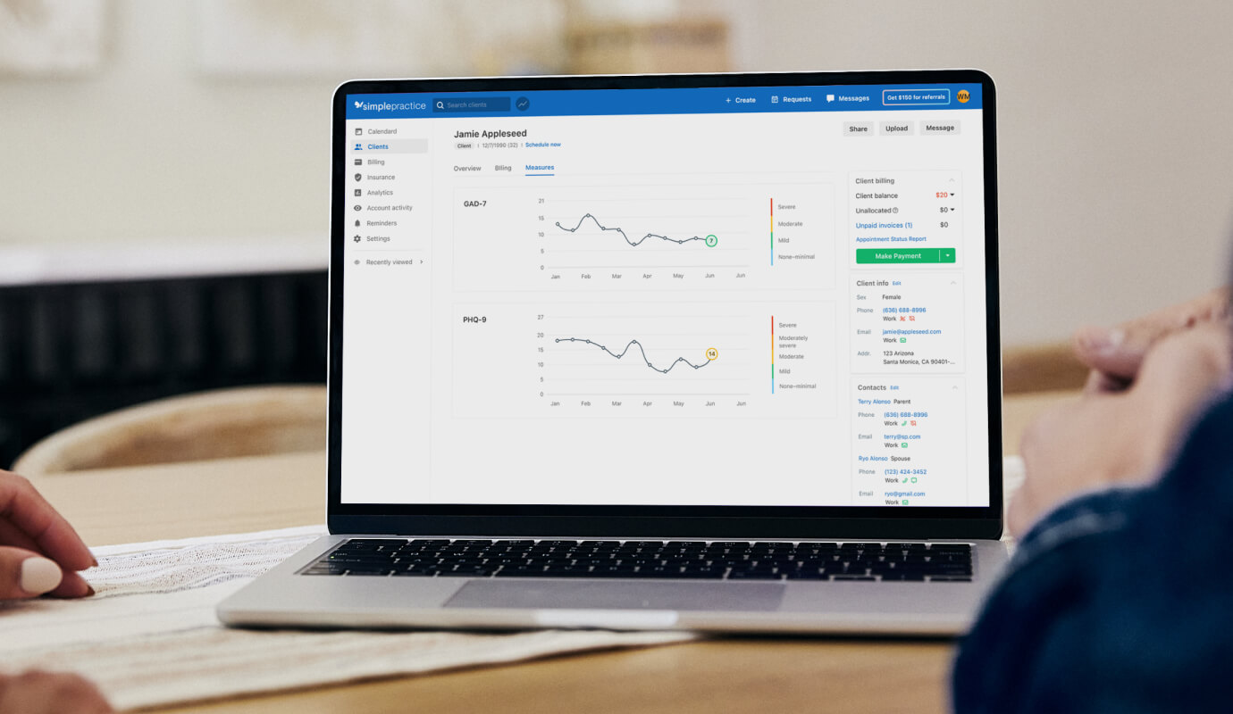 A laptop has the latest SimplePractice group practice EHR features displayed on the screen.